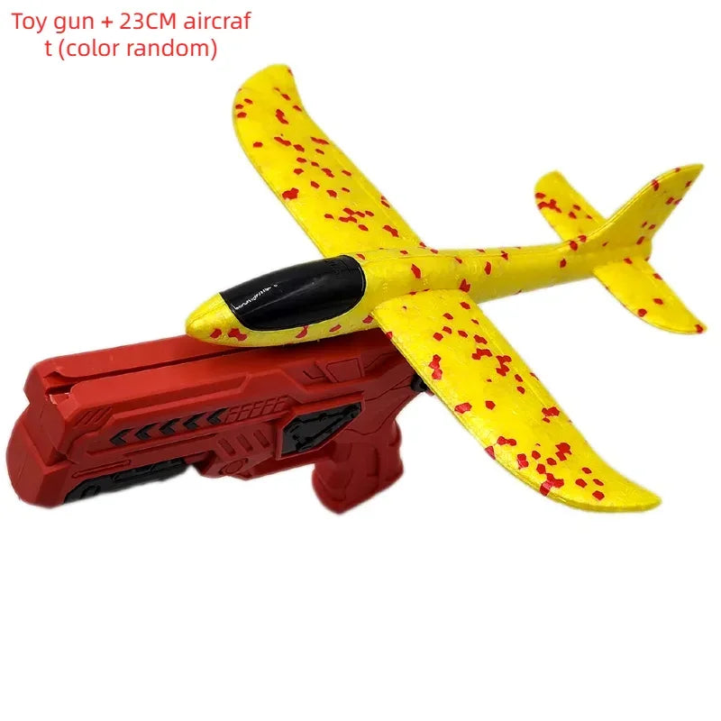 A yellow and red toy airplane glider is shown next to a red foam launcher.