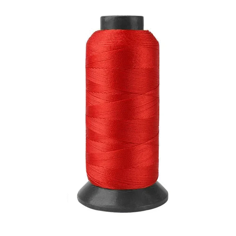 A spool of red heavy-duty nylon sewing thread for upholstery and denim.