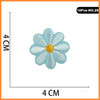 Light blue embroidered flower patch with a yellow center on a white background.