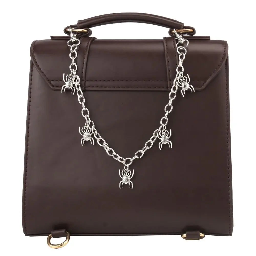A dark brown leather handbag with an elegant silver metal chain strap featuring a dragonfly charm.