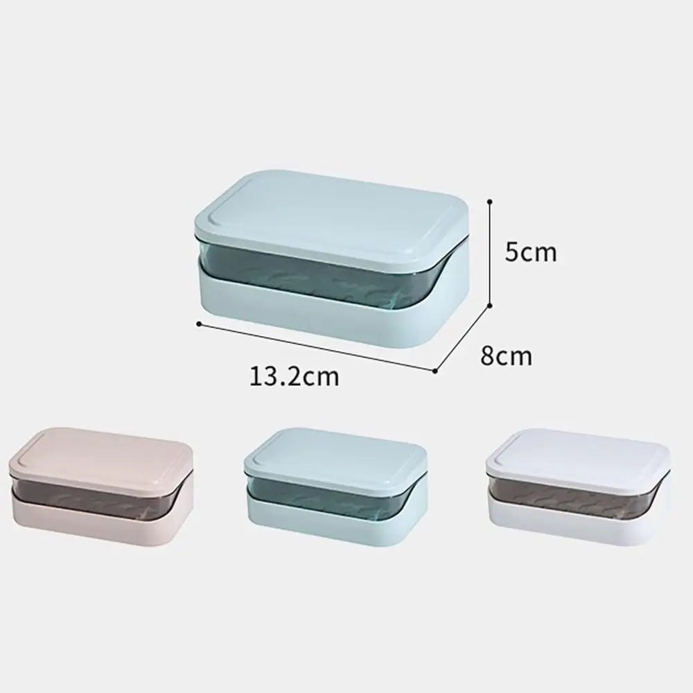 A set of three transparent soap dishes in pink, light blue, and white with drainage trays.