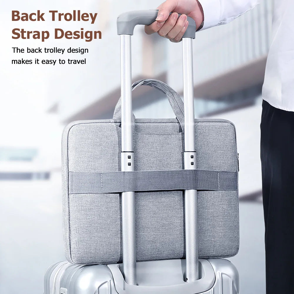 A silver laptop suitcase with a gray back trolley strap design being held by a hand.