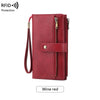 A red leather bifold wallet with a zipper closure and wristlet strap, described as wine red.
