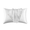 A white silky smooth satin pillowcase is shown folded and lying on a white background.