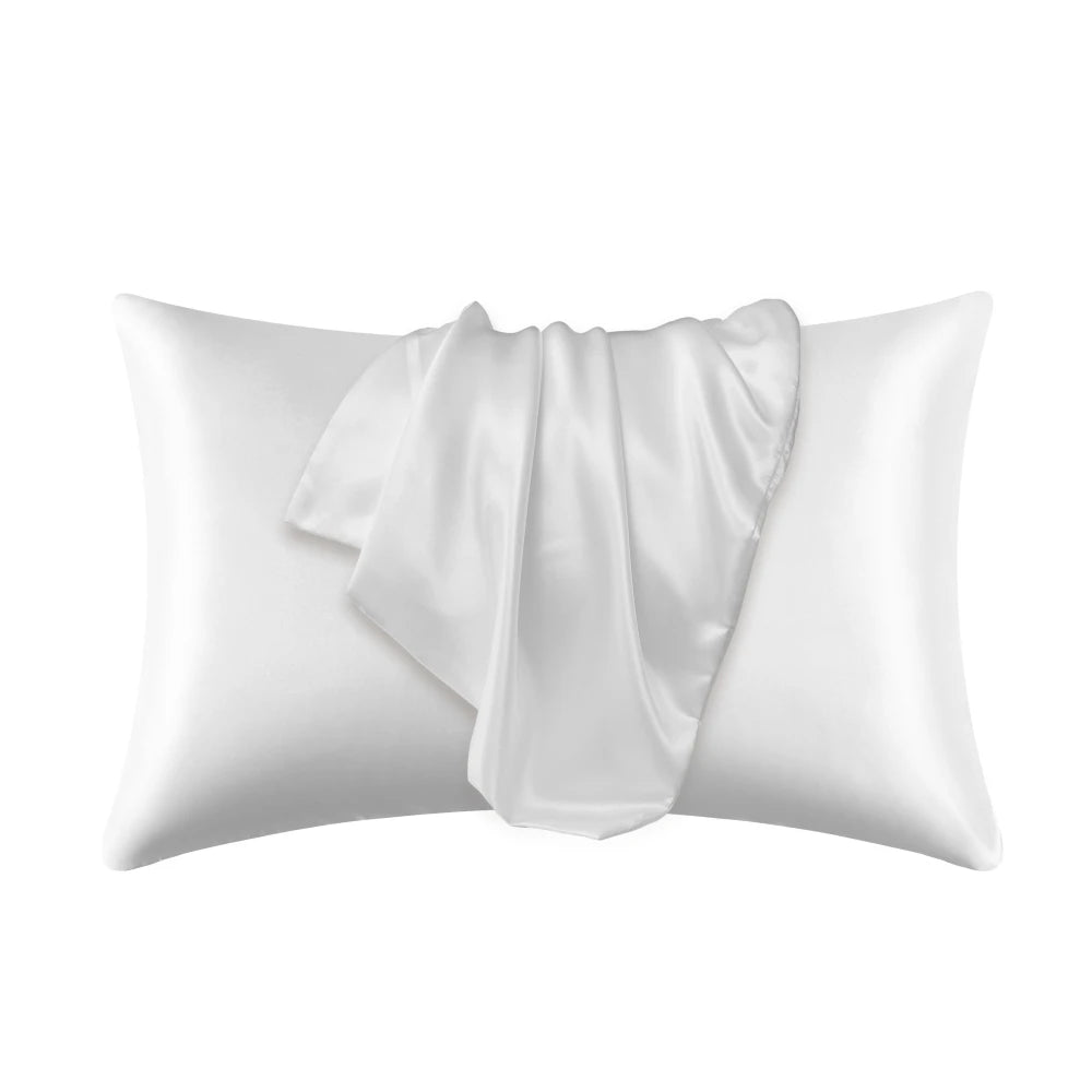A white silky smooth satin pillowcase is shown folded and lying on a white background.