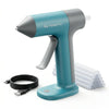 A teal cordless hot glue gun with a gray body and white nozzle is shown next to a roll of glue sticks.