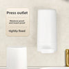 A white soap bar grinder and dispenser with a press outlet feature is shown next to a white ceramic sink.
