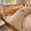 A set of light pink and tan cartoon embroidered duvet covers featuring dog faces.
