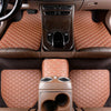 A set of five brown quilted PU leather car floor mats installed in a vehicle interior.