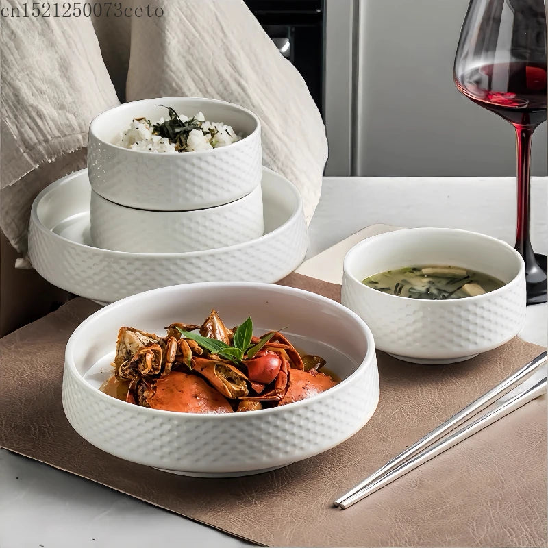 A white ceramic soup bowl filled with savory ingredients is displayed on a brown mat next to a glass of red wine.