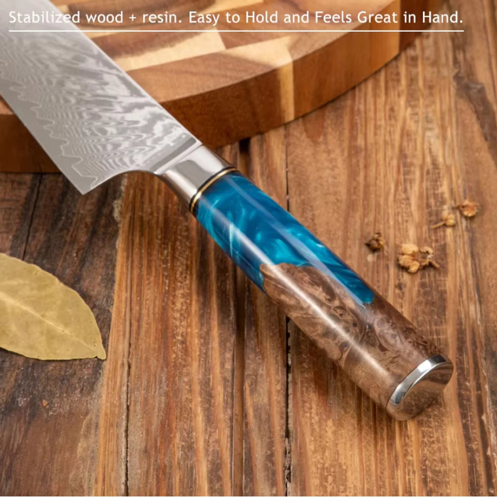 A close-up of a Damascus steel chef's knife with a blue resin handle resting on a wooden surface.