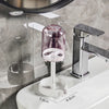 A modern bathroom toothbrush holder with a dust cover and drainage system mounted on a white ceramic surface.