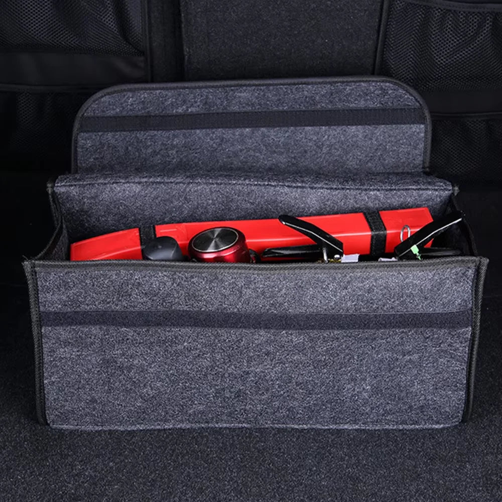 A gray foldable organizer case containing a red boot and trunk organizer.