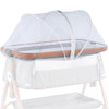 A white mosquito net cover for a baby bassinet or crib, shown resting on a wooden frame.