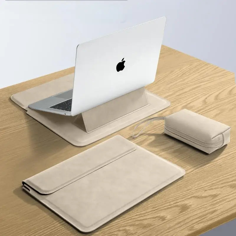 A beige slim laptop sleeve case is shown next to an Apple laptop on a wooden surface.