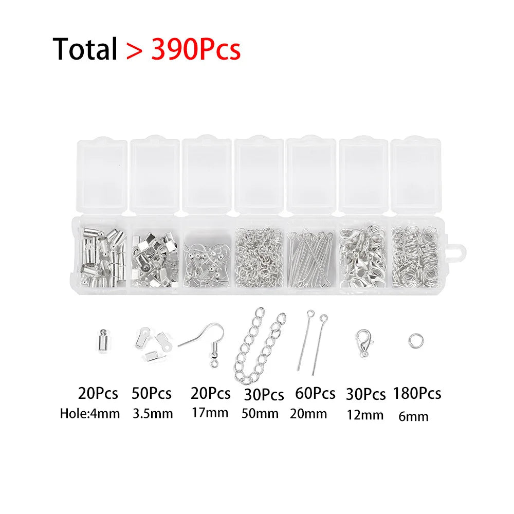 A set of jewelry making components including clasps, jump rings, and crimps packaged in clear plastic trays.