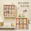 A wall-mounted display case featuring various collectible dolls arranged in tiered compartments.