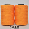 Two spools of bright orange 3-ply polyester knitting yarn for crochet and hand crafts