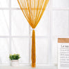 A vertical curtain made of bright golden yellow beaded thread hanging in a doorway.