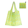 A light green reusable shopping tote bag patterned with yellow bananas and a black zipper pouch.