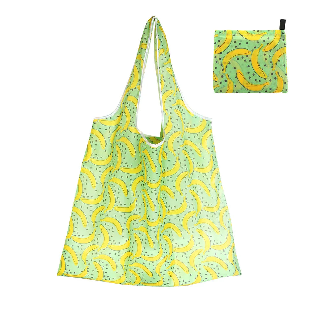 A light green reusable shopping tote bag patterned with yellow bananas and a black zipper pouch.