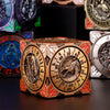 A wooden spinner dice cube featuring an eagle design and numbered faces, displayed on a dark surface.