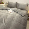 A gray cozy flannel duvet cover with a zipper displayed on a bed.