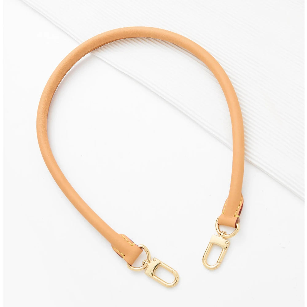 A tan synthetic leather strap for a handbag or purse, shown against a white background.