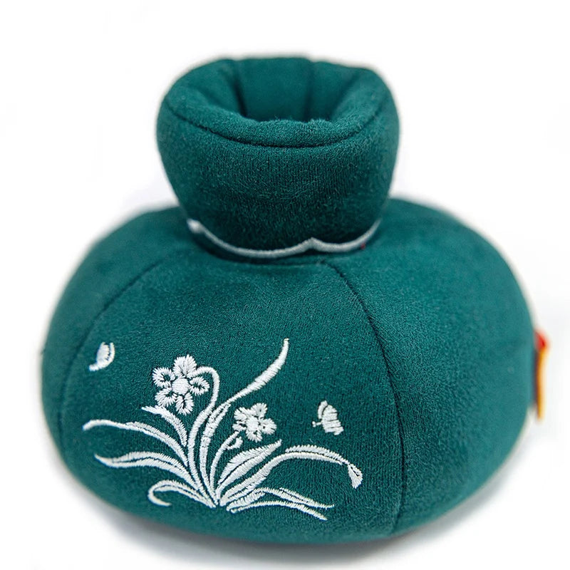 A soft green artificial flower plush doll with a rounded body and a small fabric flower detail.