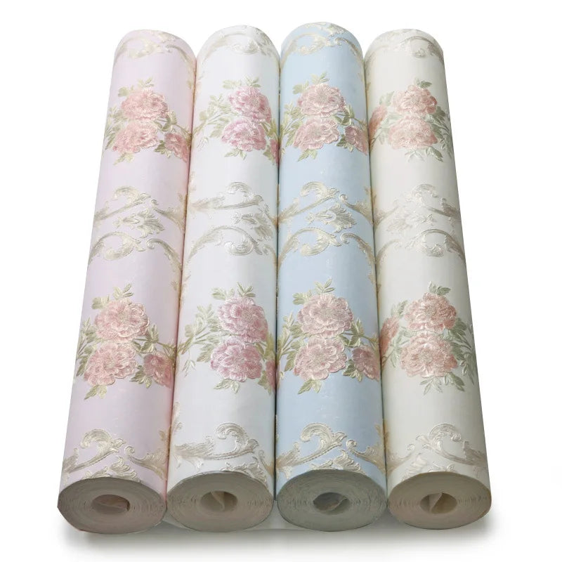 Rolls of 3D self-adhesive floral wallpaper in soft pink and blue tones.