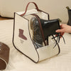 A beige storage bag with a brown handle is shown open, revealing a black boot inside.