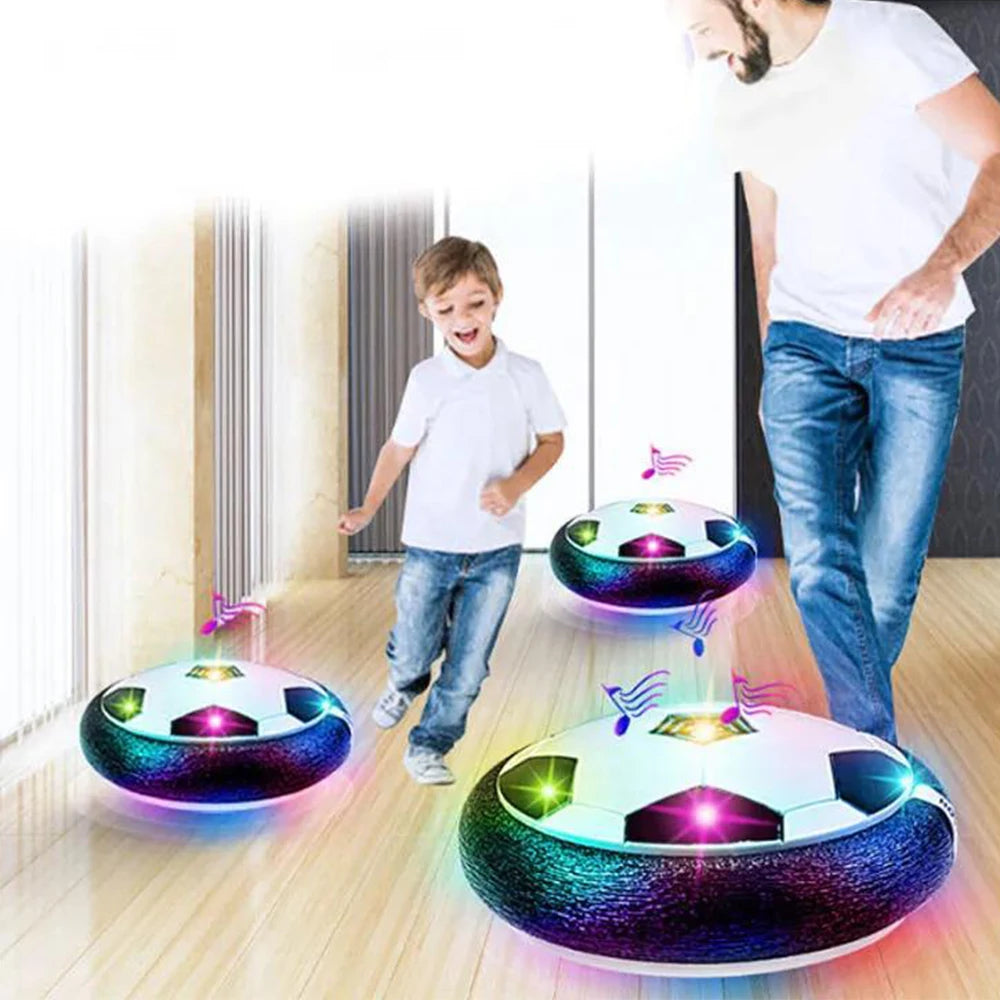 A person is playing with an LED hover soccer ball that emits light and features an air cushion technology.