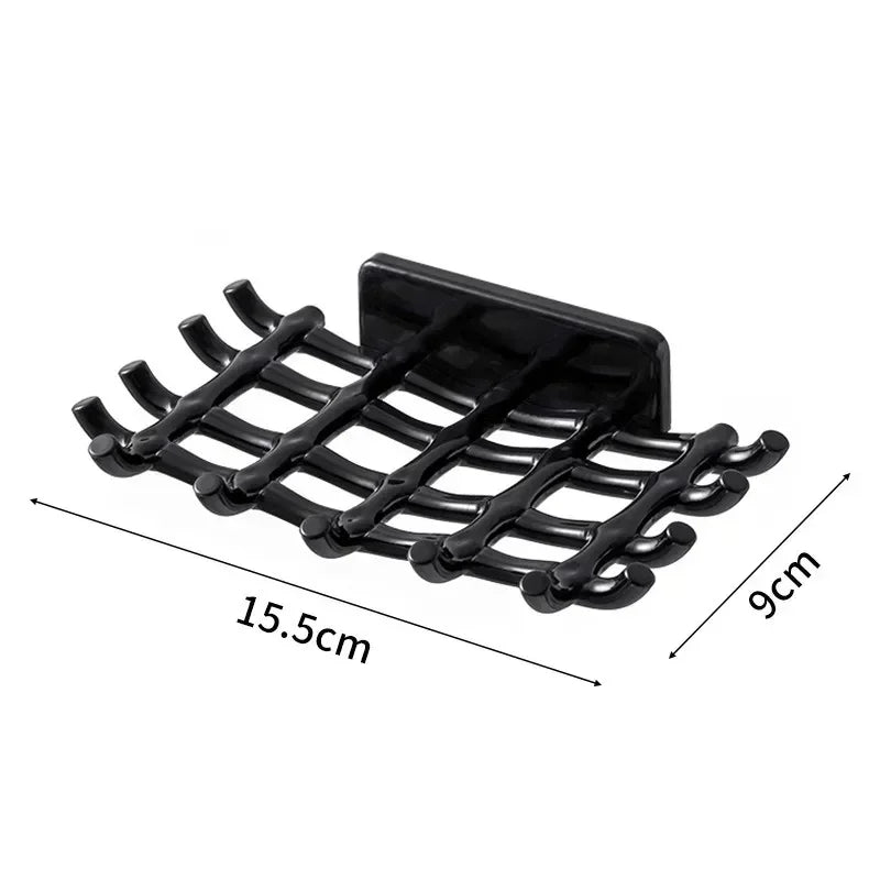 Black wall-mounted soap dish with drainage featuring multiple slotted bars.