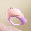 A pink and purple adjustable baby bath shampoo shield cap with ear protection is shown against a soft pink background.