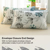 A close-up of a pillowcase featuring a teal and grey watercolor floral design, demonstrating the envelope closure end design.