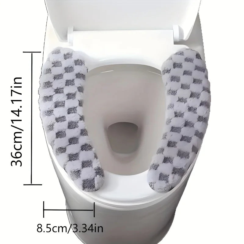 A white toilet seat with a gray and white checkered plush cushion cover installed.