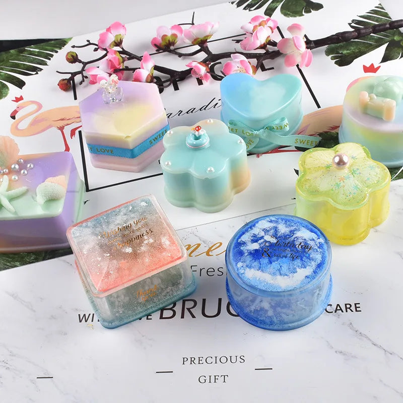 A collection of silicone jewelry boxes and resin molds in pastel colors including pink, purple, mint green, and blue, set aga