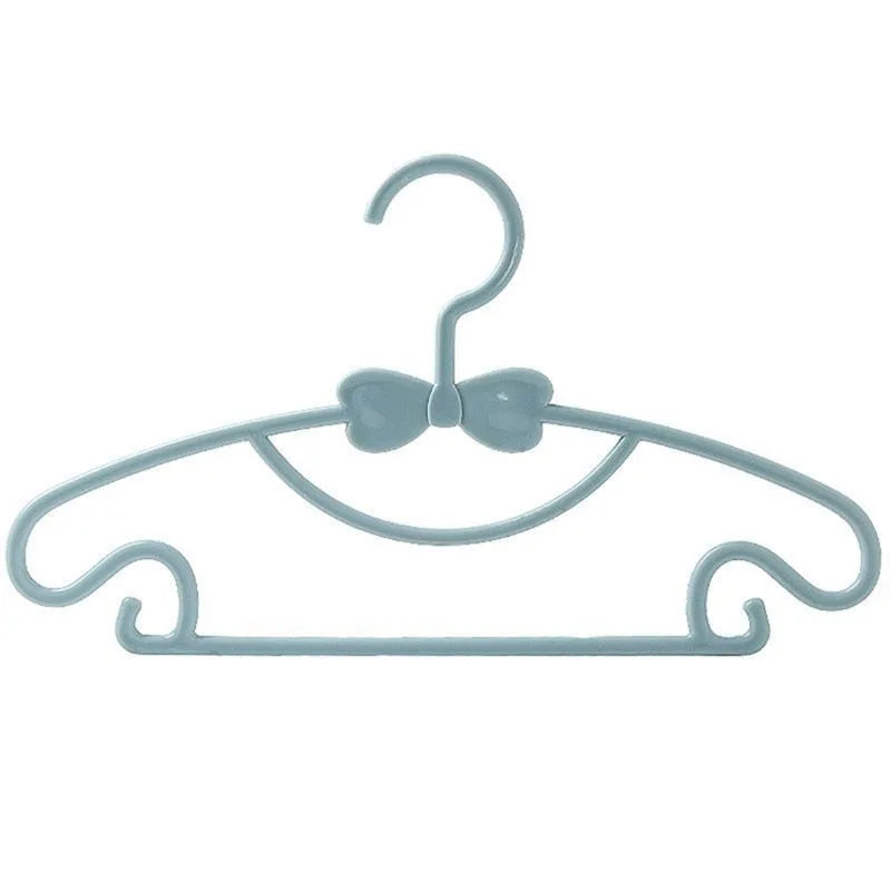 Light blue plastic hanger with a bow design for clothes