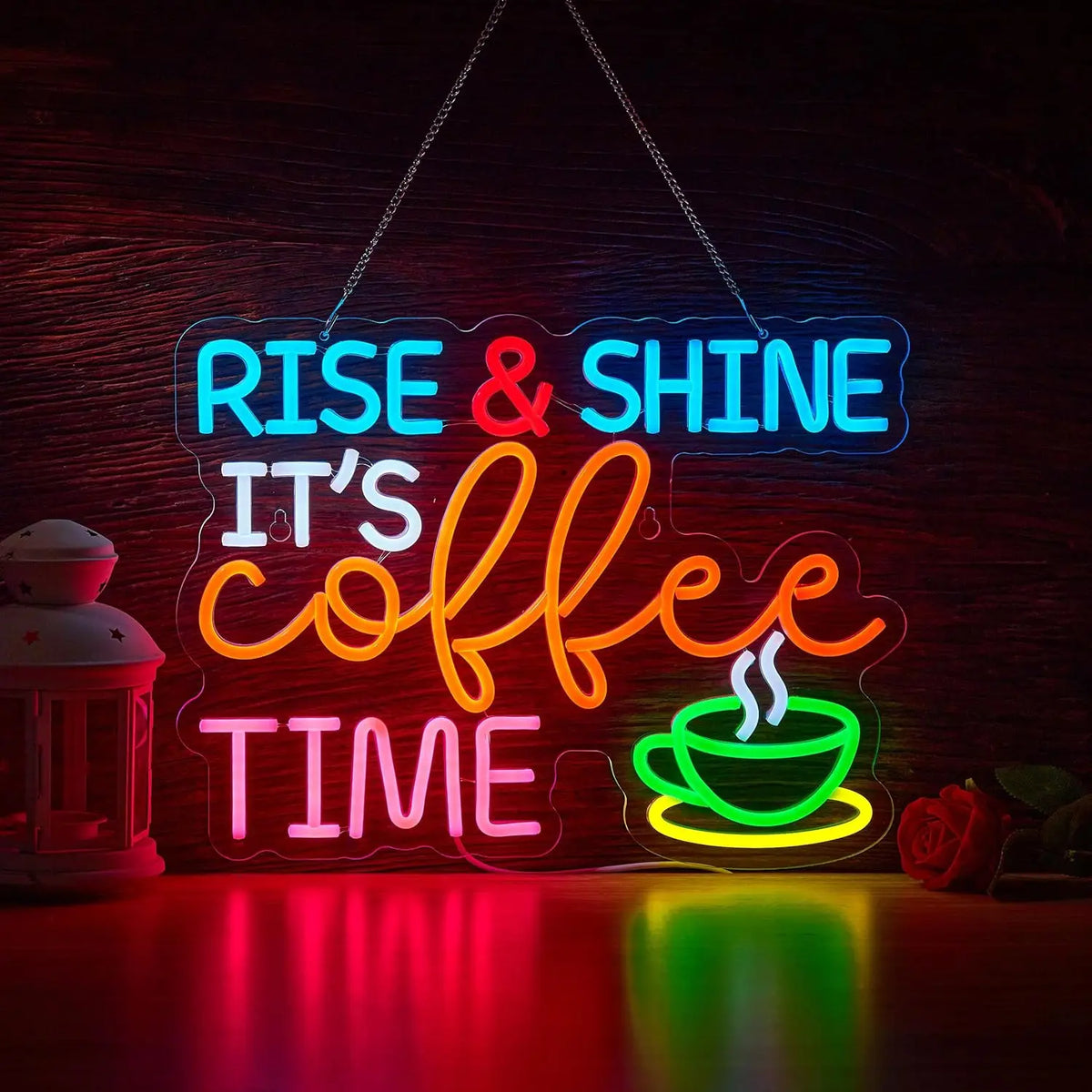 Neon sign spelling out Rise & Shine It's Coffee Time glowing brightly on a wooden surface.