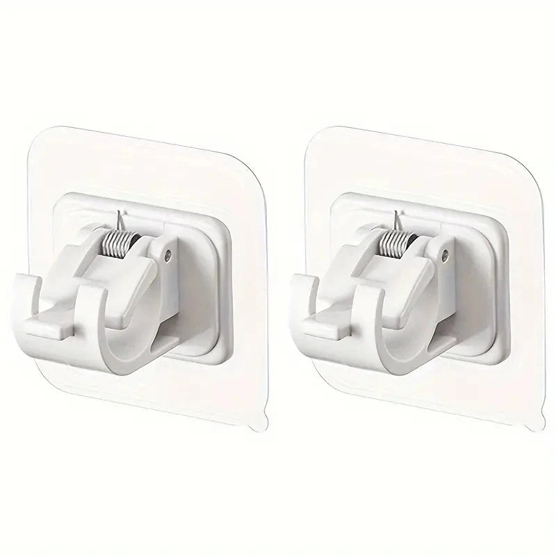 A pair of white adhesive curtain rod hooks with a no-drill wall mount clip.