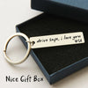 A personalized stainless steel drive safe keychain with the inscription drive safe i love you and a heart, presented in a dar