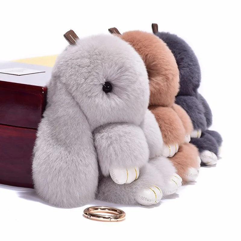 Fluffy angel bunny keychain with pom pom tail in various shades of gray and brown.