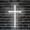 A bright white LED Jesus cross neon sign mounted on a dark brick wall.