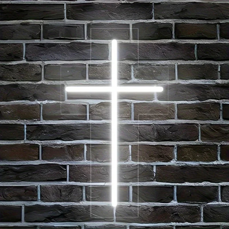 A bright white LED Jesus cross neon sign mounted on a dark brick wall.