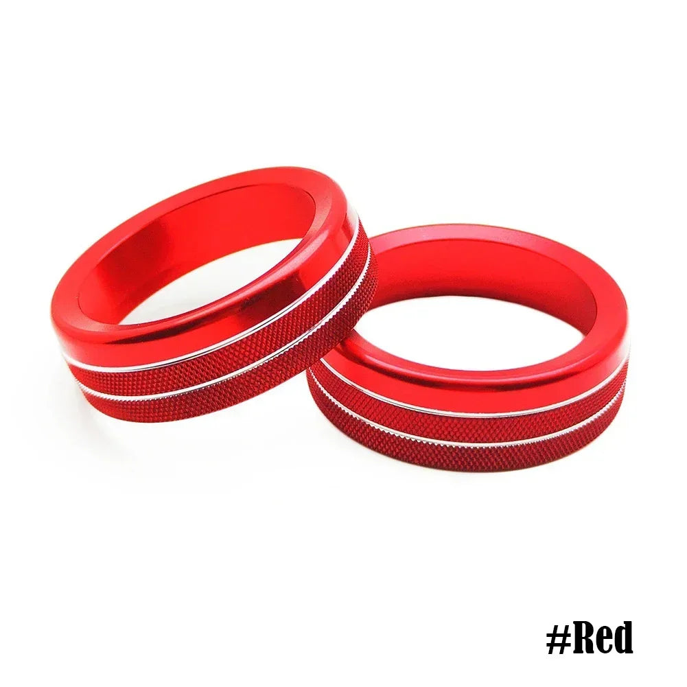 A pair of red aluminum knob trim covers for a Ford Mustang, shown against a white background.