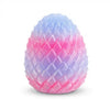A brightly colored, textured fidget egg toy with a gradient of pink and purple.