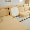 A beige Jacquard stretch sofa slipcover with a rectangular mirror accent on a light-colored sofa.