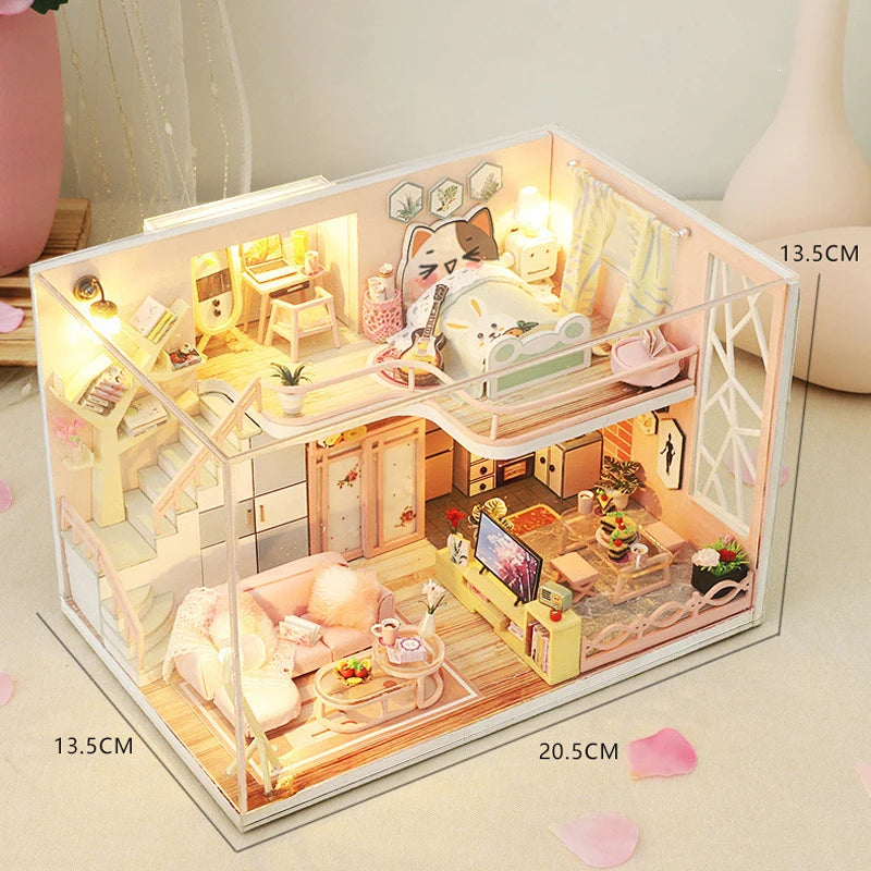 A clear acrylic miniature dollhouse building kit featuring wooden furniture and decorative elements.