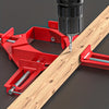 A red 90 degree right angle clamp is used to secure a piece of wooden plank for DIY projects.