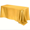 A smooth, golden yellow satin tablecloth draped elegantly on a table.